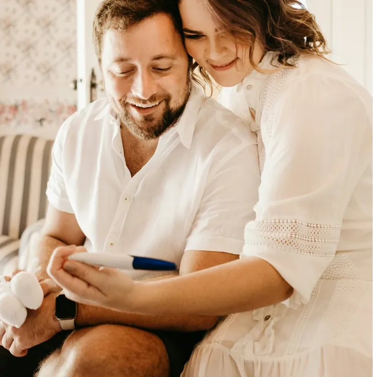 Couple reading together on a sofa