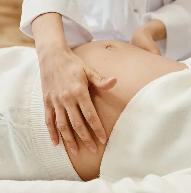 Clinician examining a pregnant patient