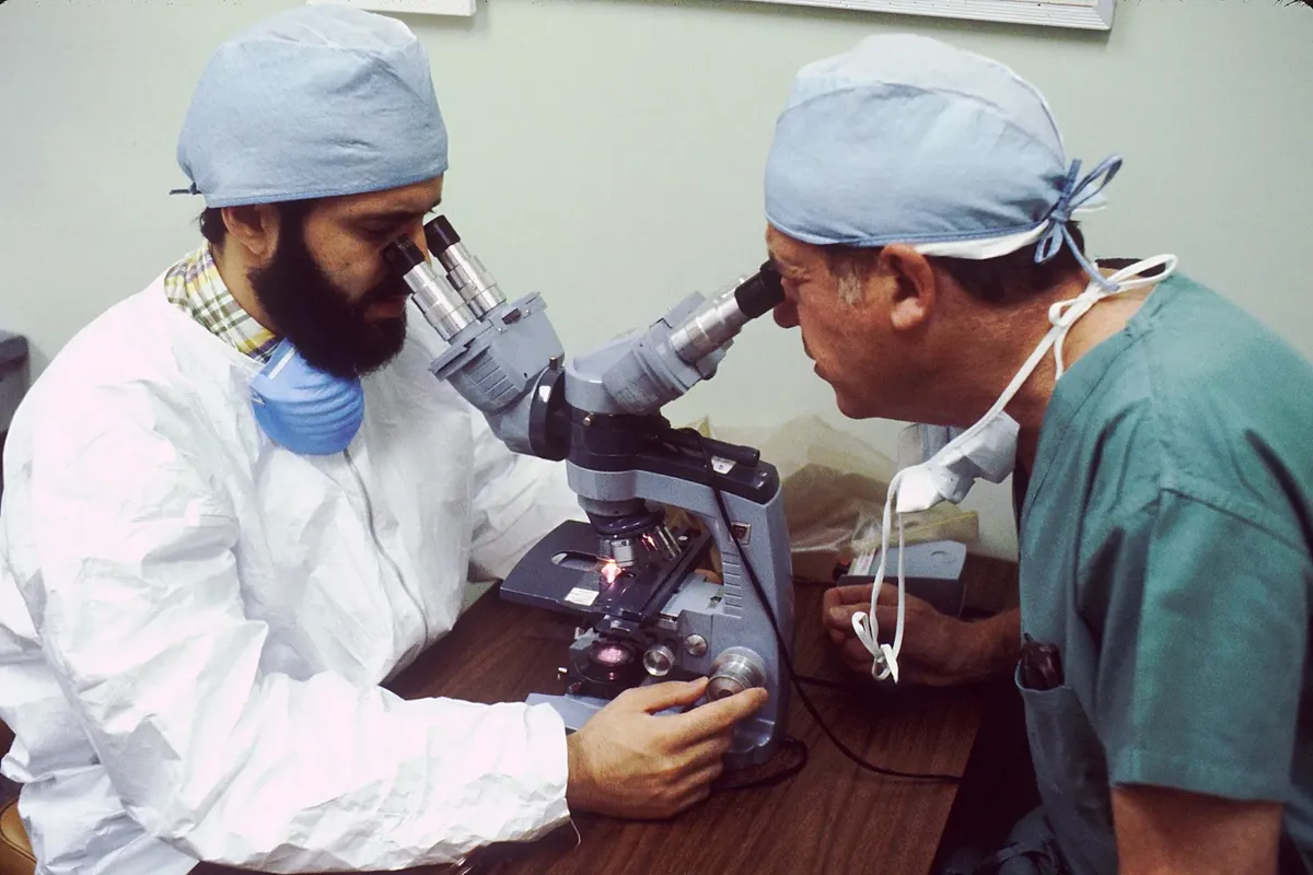Lab specialist at a microscope